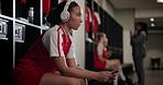 Woman, headphones and phone in locker room for music with team, streaming and inspiration for game. Person, athlete or soccer player with sport, subscription and mobile app with thinking for contest