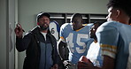 Man, football coach and whiteboard with team for game plan, strategy or discussion on formation in locker room. Male person, mentor or sports trainer talking to group for presentation on match ideas