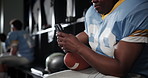 Football, player and man with smartphone, typing and social media in locker room, texting and app. Person, sports and guy with cellphone, mobile user and internet with connection and website info