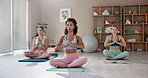 Indoor, meditation and people for yoga with namaste, holistic and inner peace with breathing in class. Mindfulness center, women yogi or praying hands for wellness, mental health or healing with calm