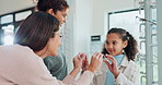 Women, optometry and child for eye care, optometrist and medical professional for consultation. Female people, glasses and specialist  with young girl at ophthalmology center for size, frame and lens