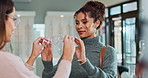 Eye care, optician and woman with glasses in store for help with frame choice, decision and eyewear option. Optometry, vision and customer with shopping for prescription lens, spectacles and advice