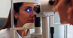 Woman, eye exam and test with light on machine for vision, sight or optometry treatment at optometrist. Female person or patient with medical technology or led lens to assess iris or optic impairment