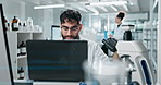 Science, lab and man on laptop for medical study, online research and website for medicine. Healthcare, biotechnology and scientist on computer for vaccine development, experiment or chemistry report