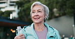 Smile, fitness and senior woman outdoor with location for walking exercise with water for hydration. Health, thinking and elderly female person with h2o beverage for cardio workout in nature.