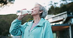 Old woman, fitness and water in outdoor for drinking, exercise break and outside for mental health. Senior person, retirement workout and relax in neighborhood, cardio and bottle of mineral liquid