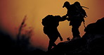 Sunset, mountain and shadow of men helping on cliff for view in nature with camping backpack and support. Outdoor, travel and adventure with journey, trekking and trip at dusk with friends silhouette