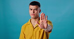 Portrait, palm or man with no hand gesture in studio on blue background for bad behaviour to stop abuse. Angry, portrait or body language with warning, danger or person in disagreement or protest