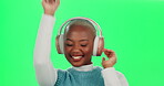 Black woman, studio and dancing with headphones in green screen for music, fun and entertainment. Female person, studio and happy or smile with audio sound, radio and song with online streaming