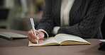 Hand, notebook and business person writing at desk with pen for meeting schedule, agenda or project feedback. Closeup, journalist and employee for planning, information or reminder in office