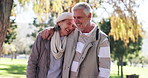 Senior couple, talking and walking in park for bonding together, love relationship and support. Old people, hug and morning stroll in nature with hug, conversation and happy marriage in retirement