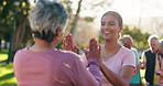 Senior, woman and high five with personal trainer outdoor for good job, well done and complete rehabilitation exercise. Mature person, girl and hand gesture in park or nature for wellness achievement