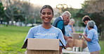 Portrait, happy woman and volunteer in nature with box, donation and contribution for community service. NGO, smile and female member in park with pride, charity and package for social responsibility