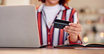 Woman, hands and laptop with credit card for online payment, shopping or banking on table at home. Closeup of female person or shopper with computer or debit for transaction, fintech or ecommerce