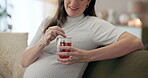 Hands, herbal tea and wellness with pregnant woman on sofa in living room of home for prenatal health. Belly, detox and drink with happy mother of baby in apartment, thinking of future or maternity