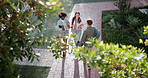 Students, women and campus at university, college or school with walking, friends and greeting. Female people, conversation and high angle of residence, career center or outdoor ground for education