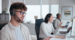 Call center, talking and man with headset in office for customer service, online advice or telemarketing. Help, contact us and consultant in discussion for communication, assistance or tech support 