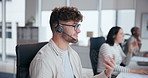 Call center, discussion and man with headset in office for customer service, online advice or telemarketing. Help, contact us and male consultant for communication, assistance or tech support 