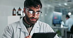 Science, laboratory and man on tablet for medical analysis, online research and medicine. Healthcare, biotechnology and male scientists on digital tech for sample, experiment and vaccine development