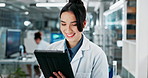 Woman, scientist and tablet with reading in laboratory with smile at pharmaceutical company. Person, touchscreen and notes on application, research and development for medicine, drugs and vaccine