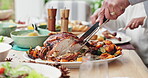 Hands, person and carving turkey for thanksgiving dinner, table setting and nutrition for gathering, event and home. Family, celebration and party with food, festive and feast for holiday or vacation