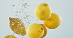 Lemons, water and bubble for vitamin c drink, tropical and summer beverage in studio for detox. Fruit, citrus soda and organic juice on white background, fresh produce and antioxidant for hydration