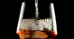 Glass, whiskey and ice with scotch, alcohol and bourbon on black studio background. Empty, cold and smooth drink with refreshment, pouring and cube with closeup, luxury and liquor with rum and cognac