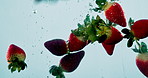 Strawberry, nutrition and natural fruit with water splash for vitamin c, fresh produce or wash on a blue background. Closeup of wet organic food, juicy or sweet for hydration, healthy diet or fiber