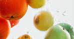 Fruit, water and mix with vitamin c for nutrition, fresh produce or hydration in wash on a black background. Closeup of juicy, natural organic food or citric acid in wet splash for healthy diet