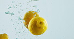 Fruit, lemon and water with vitamin c for nutrition, fresh produce or hydration in studio on a white background. Closeup of juicy, natural organic food or citric acid in wet splash for healthy diet