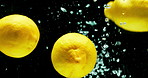 Lemon, water and citrus fruit with vitamin c for fresh produce, hydration or wash on a black background. Closeup of natural organic food, nutrition or citric acid in splash for healthy diet or fiber