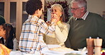 Happy, senior and grandparents play with child on table for thanksgiving lunch, fun game and bonding together. Smile, interracial family and boy with brunch reunion, care and love for trust at house