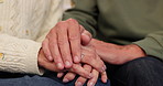 Home, old couple and holding hands with love, care and support with comfort, grief and loss. Closeup, man and woman with empathy, sympathy and sad with understanding, trust and respect with gratitude