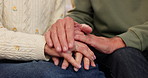 Home, old couple and holding hands with anxiety, care and support with comfort, grief and loss. Closeup, man and woman with empathy, sympathy or sad with understanding and tremor for cancer diagnosis