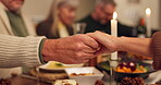 Hands, people and prayer with food for thanksgiving dinner, celebration and reunion on meal. Night, candles and family on dining table with grace for support, appreciate and unity to respect at home