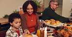 Happy family, dining and food with table for thanksgiving dinner, meal or supper together at home. Mother, father and child with bread for feast, serving or eating for holiday or celebration at house