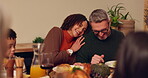 Happy family, couple and dinner for thanksgiving in home with love, food and gratitude for holiday celebration. Man, woman and hug by table with laughter or embrace, feast and reunion with relatives