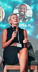 Conference, microphone and businesswoman on a stage at event for financial forecasting forum. Speaker, corporate and board of director with revenue, profit or dividend of shareholders discussion.