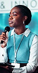 Conference, microphone and businesswoman with tablet on a stage at event for financial forecasting forum. Speaker, presentation and finance executive with revenue, profit or dividend of shareholders.
