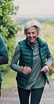 Senior people, running and fitness for retirement, wellness and cardio health outdoor while running. Elderly couple, interracial and talking for workout, exercise and bonding in nature as vertical