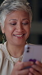 Happy, mature and business woman with smartphone in office for networking, laughing and social media meme. Female employee, night and working late for mobile distraction, online and communication.