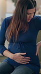 Pregnant woman, breathe and labor cramps in home, abdominal agony and injury ache on sofa. Female person, uncomfortable motherhood and stress on uterus for medical emergency, backpain and worry