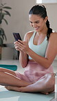 Texting, woman and smile for message, yoga and relax on mat in gym, online or happy for communication. Health club, social media and typing of girl on app, rest or person on break, pilates or workout