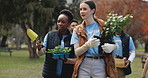 Nature, walking and volunteers in conversation with plant in park for community service, sustainability or gardening. Charity, outdoor and ngo workers with leaves for eco friendly outreach project.