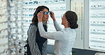 Women, optometry and choosing glasses in eye care, clinic and consultation at optometrist. Female people, spectacles and option by medical professional or ophthalmology center for size, frame or lens