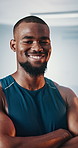 Black man, smile and arms crossed in gym for training, strength or muscle building for fitness club development. Confidence, portrait and happy African person for workout, exercise and challenge