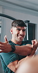 Fitness, personal trainer and stretching in gym for class, warm up and smile for motivation in lesson. Man trainer, advice and group in wellness center for exercise, development and ready for workout