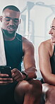 Couple, gym and happy for fitness on smartphone on internet for entertainment and funny videos. People, body builder and smile on social media post with tips for workout, training and exercise