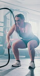 Woman, battle rope and exercise for fitness at gym with power training, resilience workout or strong muscle. Female athlete, equipment and growth performance, cardio challenge and speed of sport club