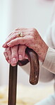 Old woman, hands and cane for help in home, osteoporosis and arthritis assistance on couch. Senior, recovery and walking stick for rehabilitation support, person with disability and parkinson aid